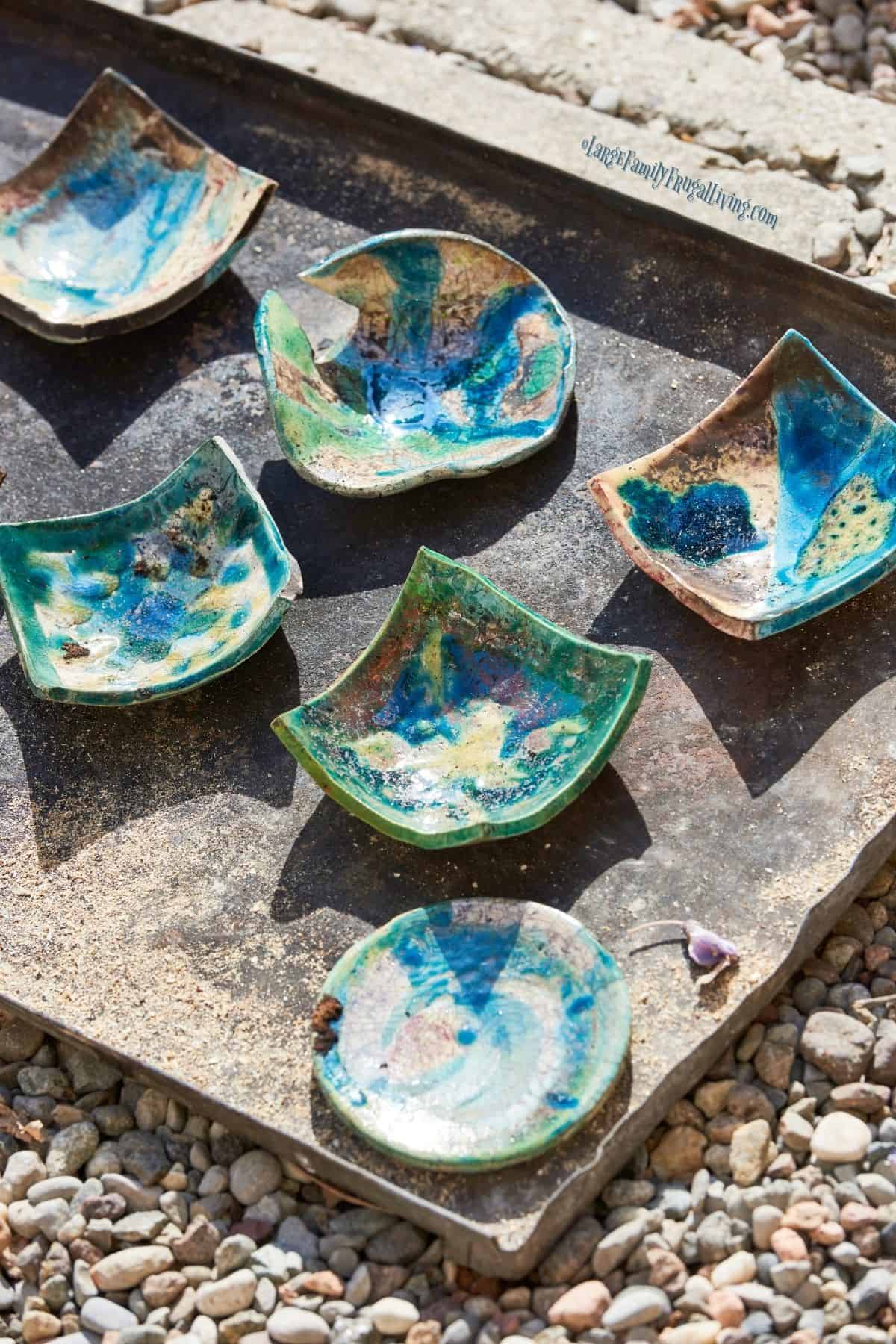 Decorated pottery pieces of raku ceramic soon after removed from oven
