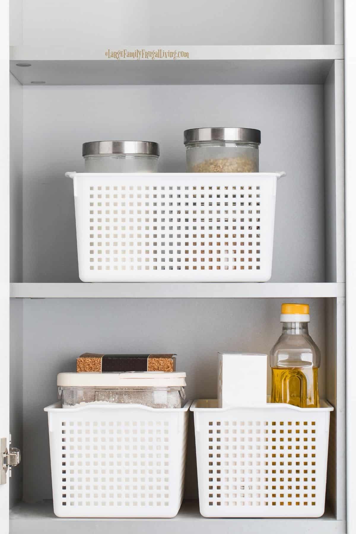 Storage of dry food in containers kept in plastic bins in a pantry cabinet