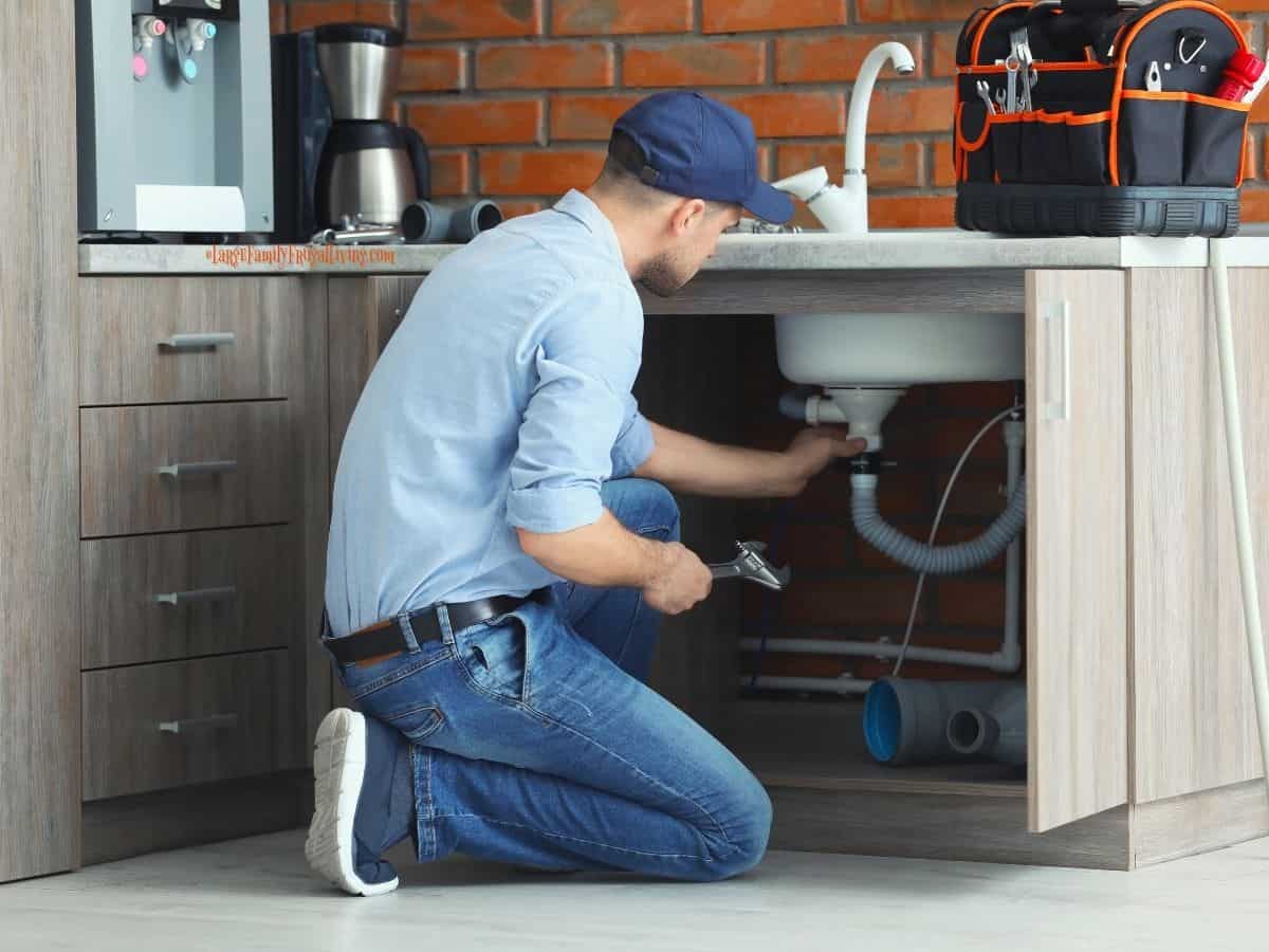 Professional Plumber fixing kitchen sink