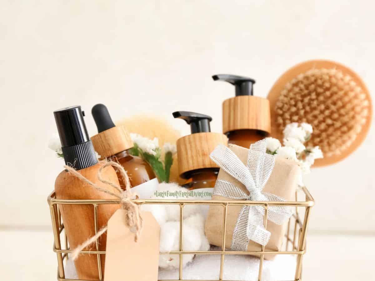 Wire basket with wood and glass bottles of health and beauty products and tools for application; gift basket for pampering